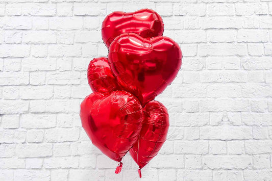Bunch of heart-shaped balloons for hire to add a romantic touch to parties, weddings, and celebrations