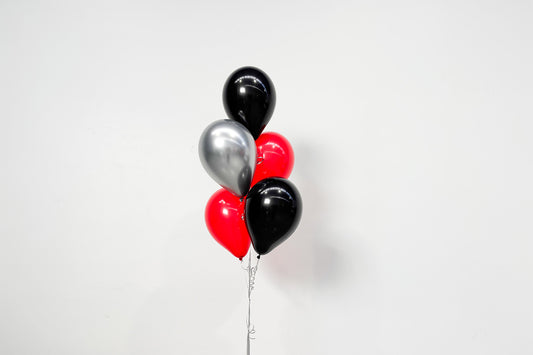 Colourful helium balloon bunch floating above a weighted base, perfect for birthdays, corporate events, weddings, and celebrations in Auckland.
