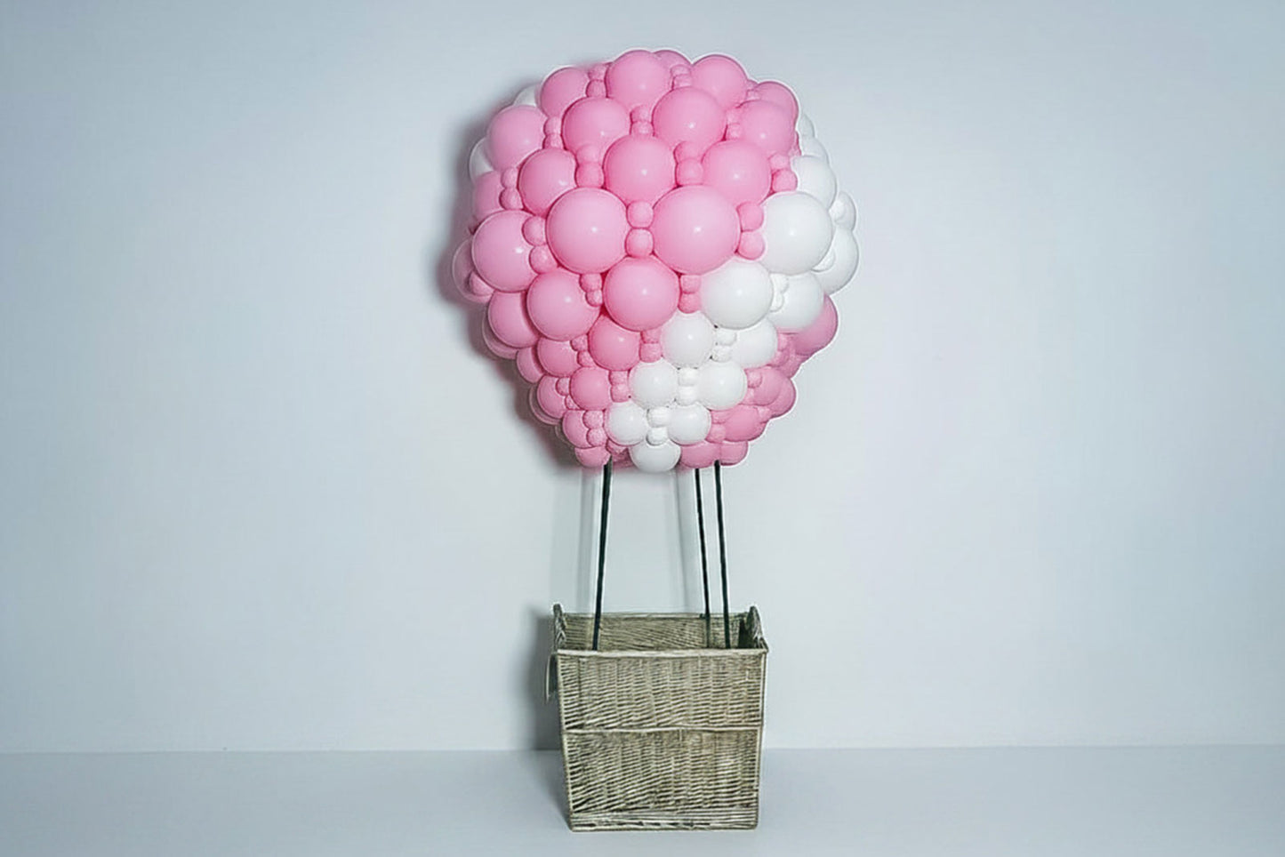 Colourful hot air balloon sculpture display created with balloons for a themed event backdrop.