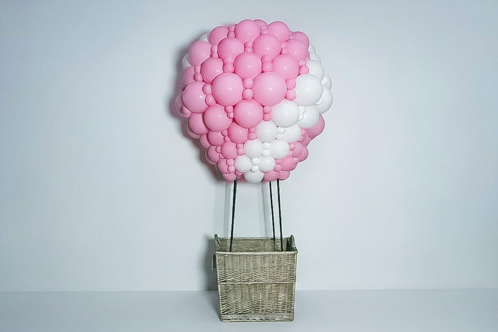 Colourful hot air balloon sculpture display created with balloons for a themed event backdrop.