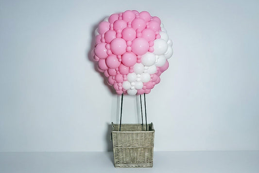 Colourful hot air balloon sculpture display created with balloons for a themed event backdrop.