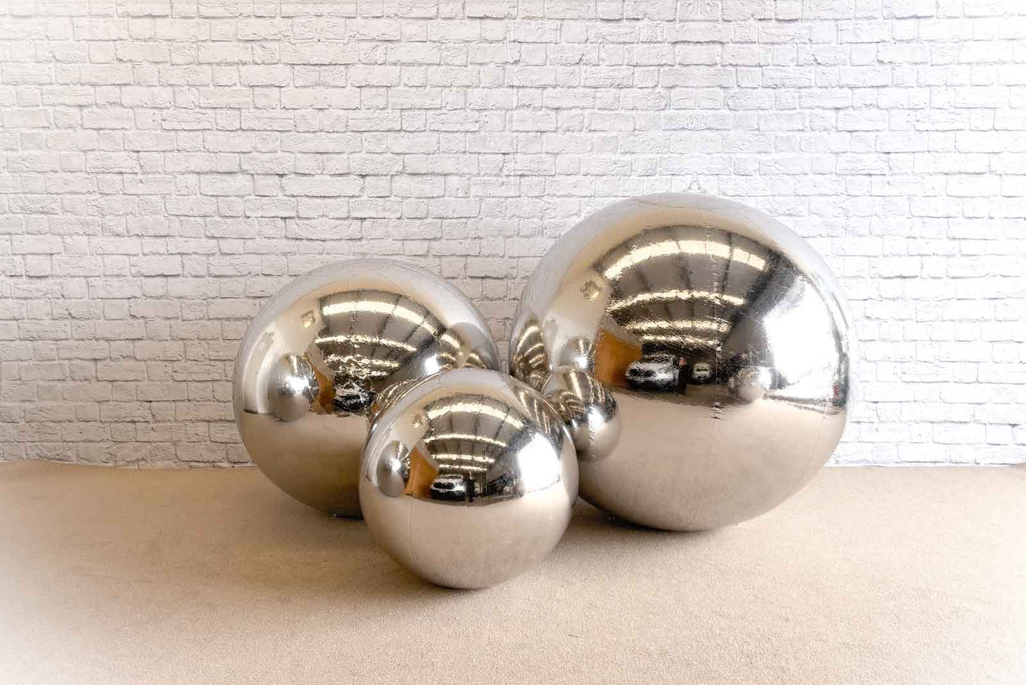 Large silver inflatable balls for festive celebrations