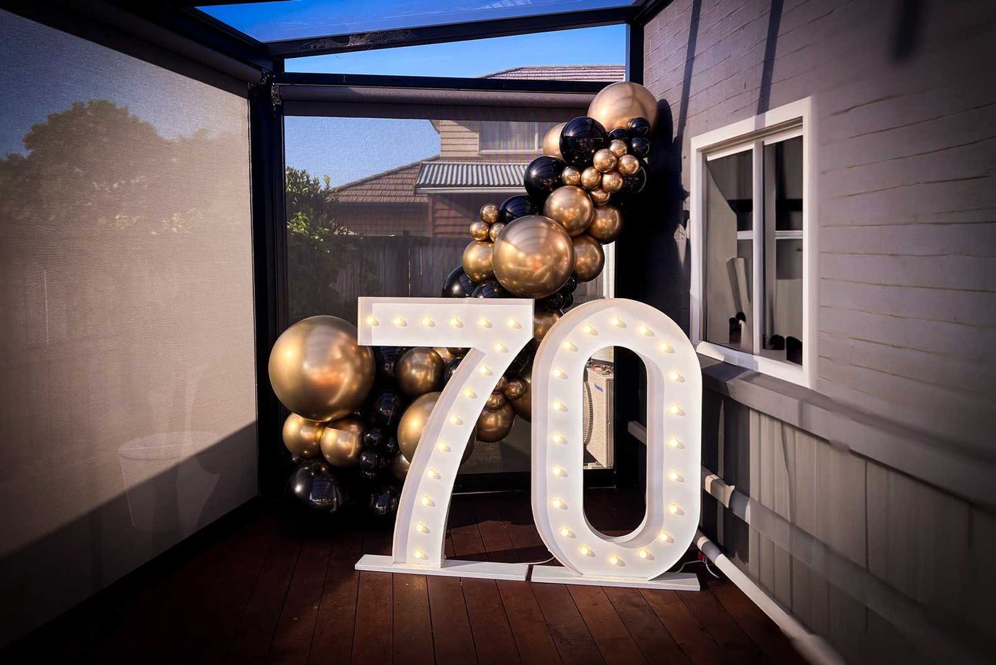 LED light up numbers with balloon garland party setup