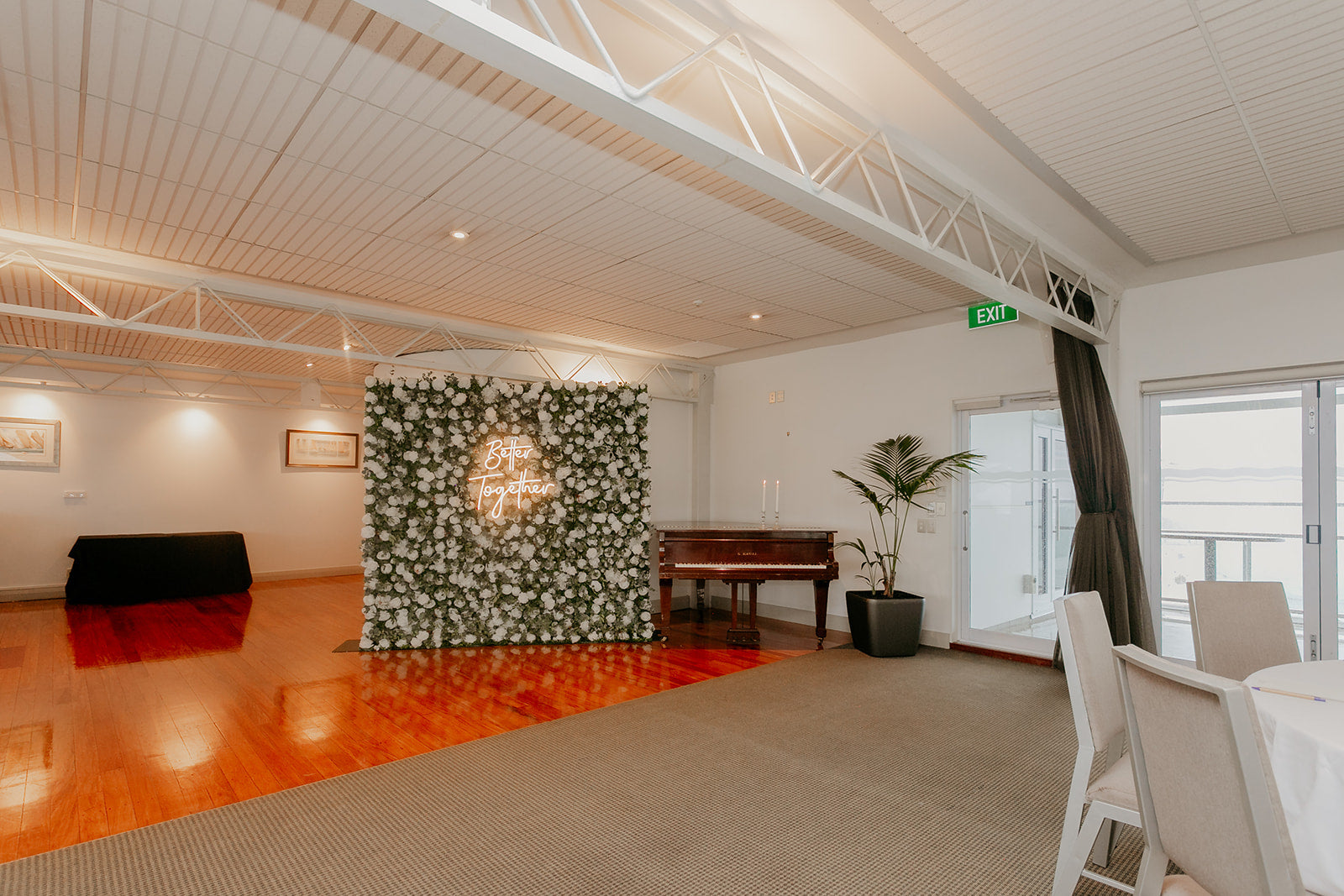 Luxury floral wedding wall paired with "Better Together" neon sign for memorable celebrations