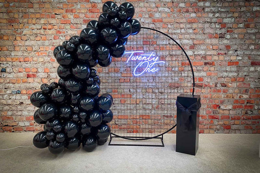 Mesh circle backdrop with Twenty One neon sign for 21st birthday party or event décor