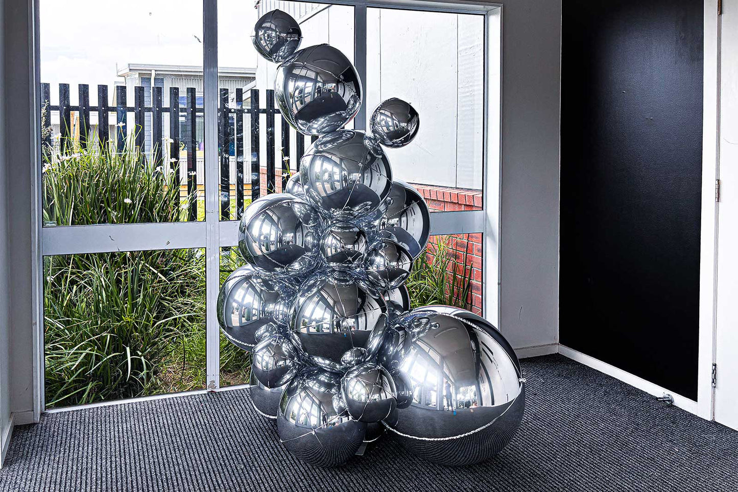 Metallic silver foil ball tower display for professional event décor