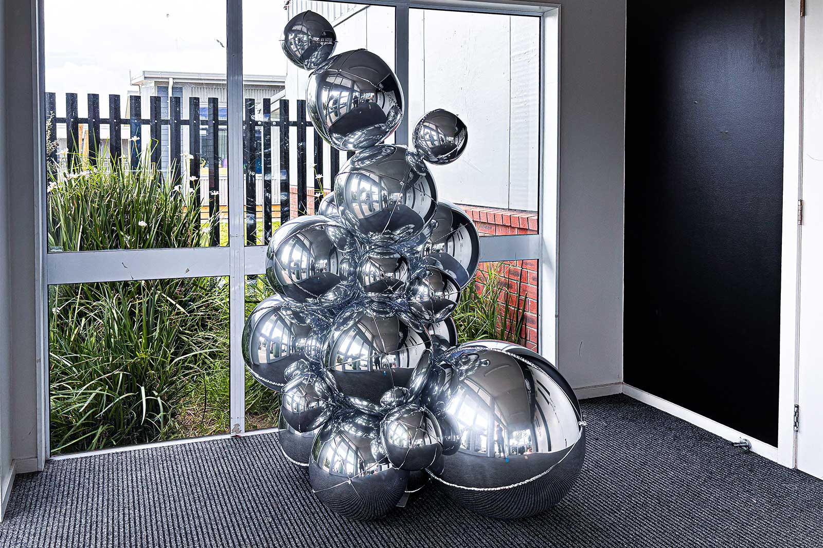 Metallic silver foil ball tower display for professional event décor