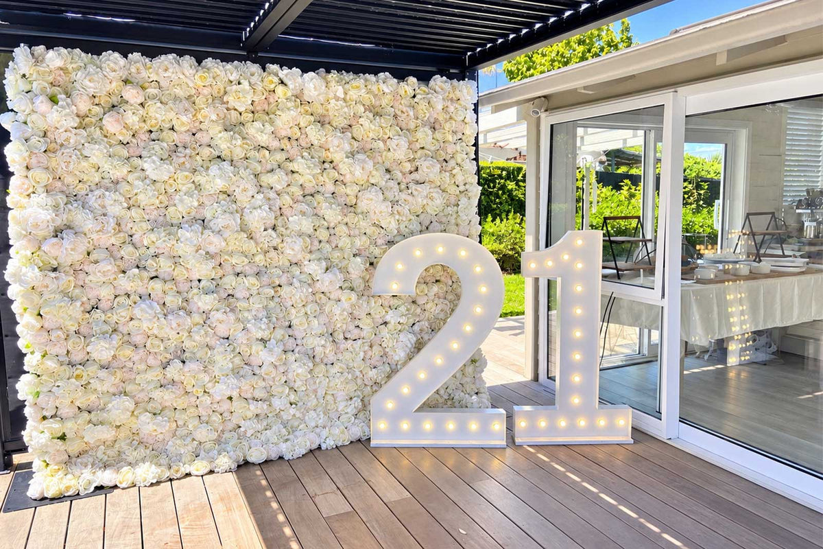 All-white Miss Ella flower wall backdrop for an elegant 21st birthday celebration