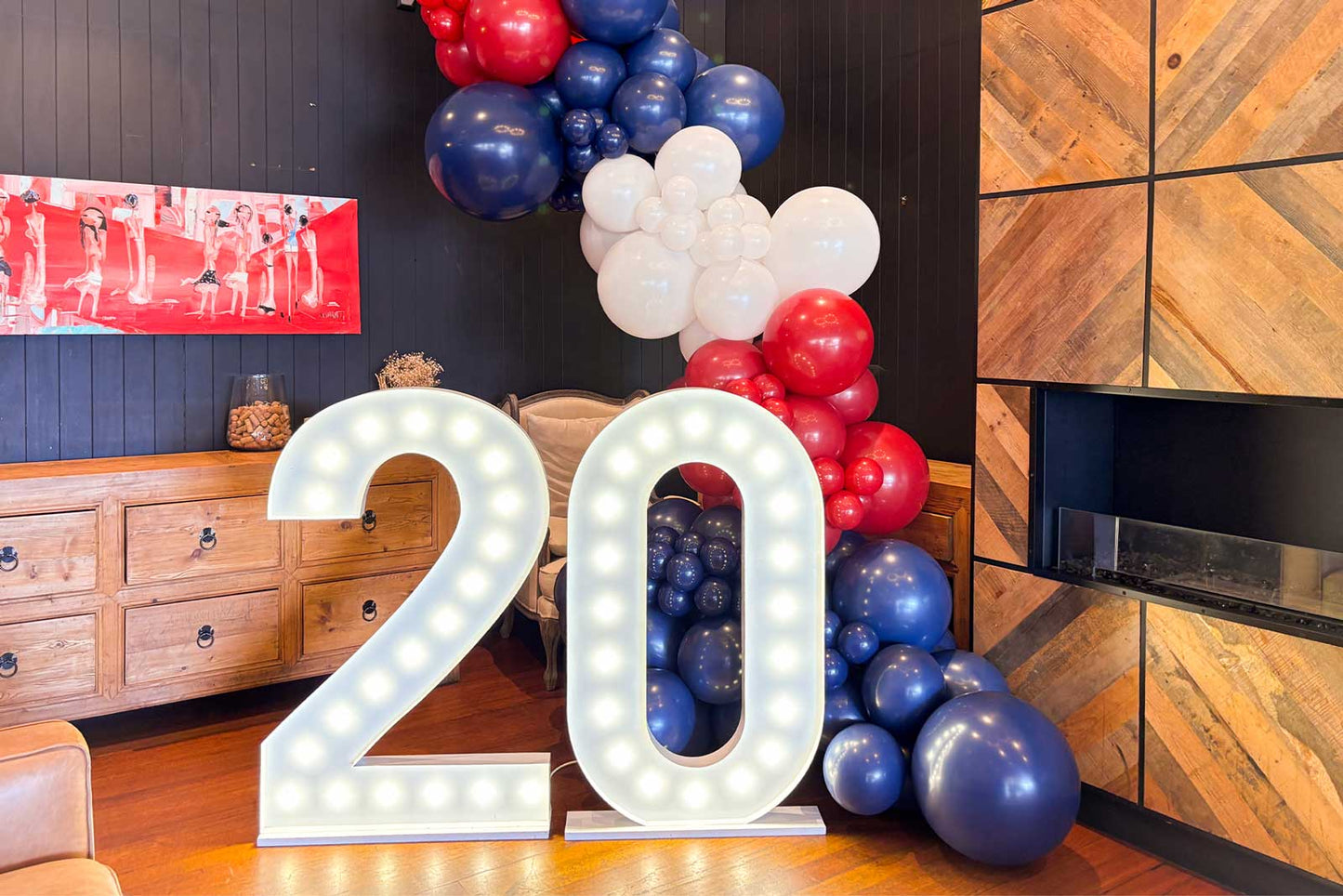 Number 20 marquee lights with balloon garland for celebration"