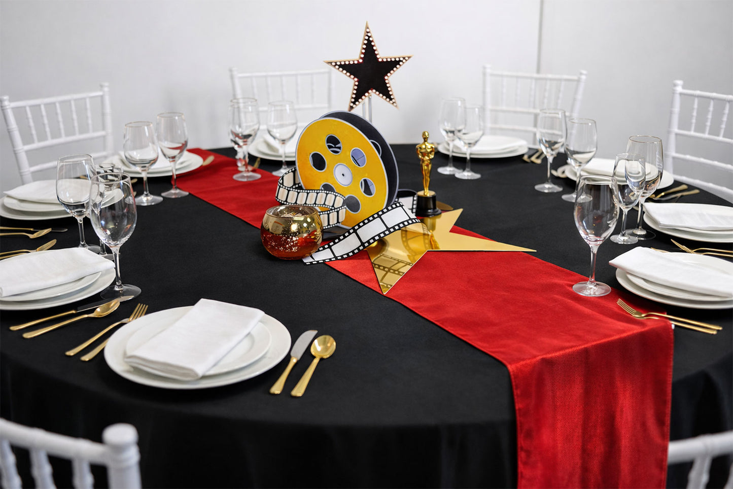 Luxury Oscars-themed gala centrepiece with gold and black decor, perfect for award night tables