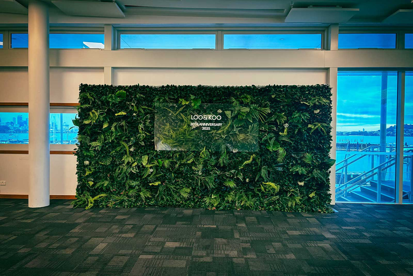 Palm jungle photo wall backdrop creating a vibrant tropical setting for event photography and celebrations