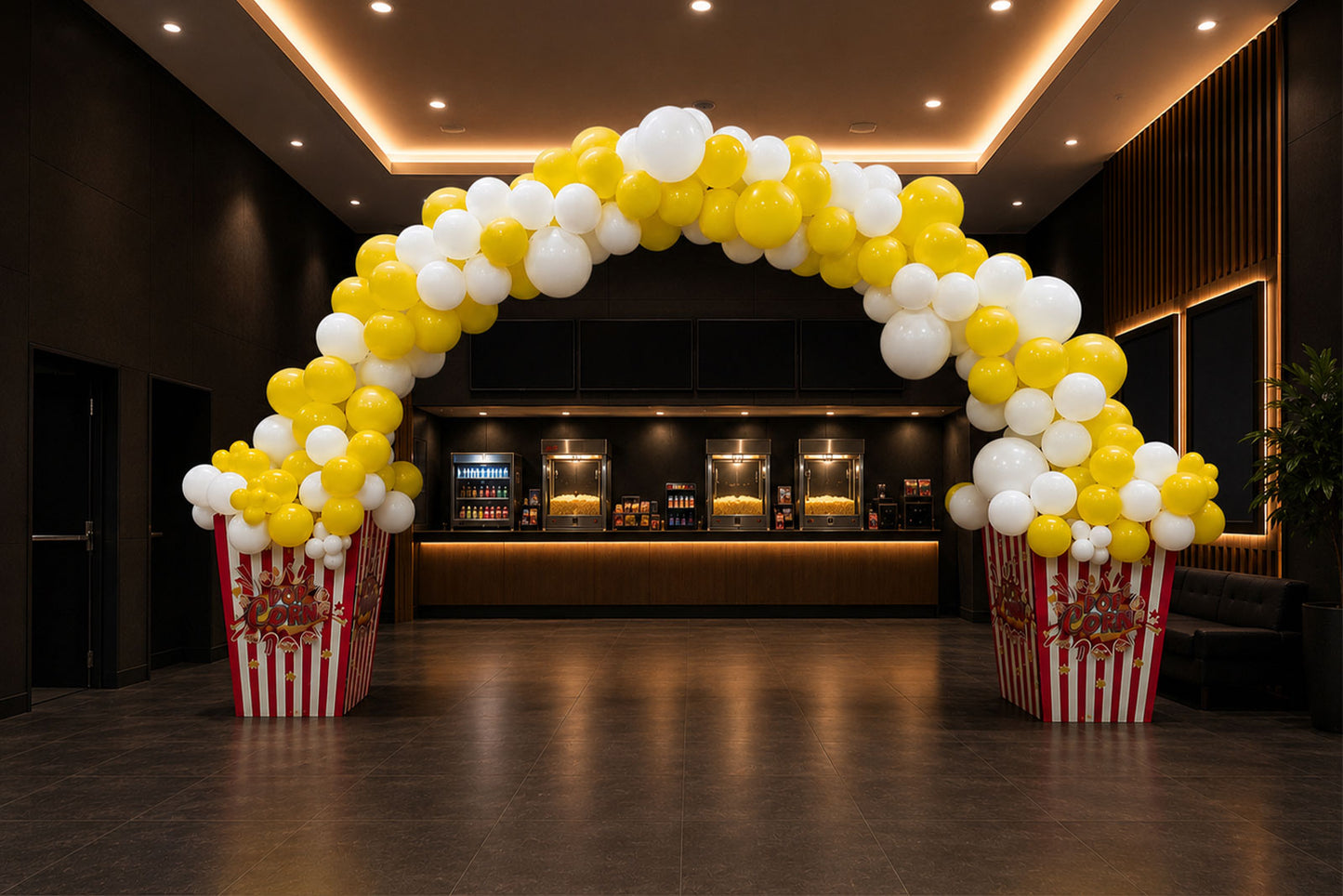 Popcorn themed balloon arch with red, white and yellow balloons for cinema, movie night and carnival events in Auckland
