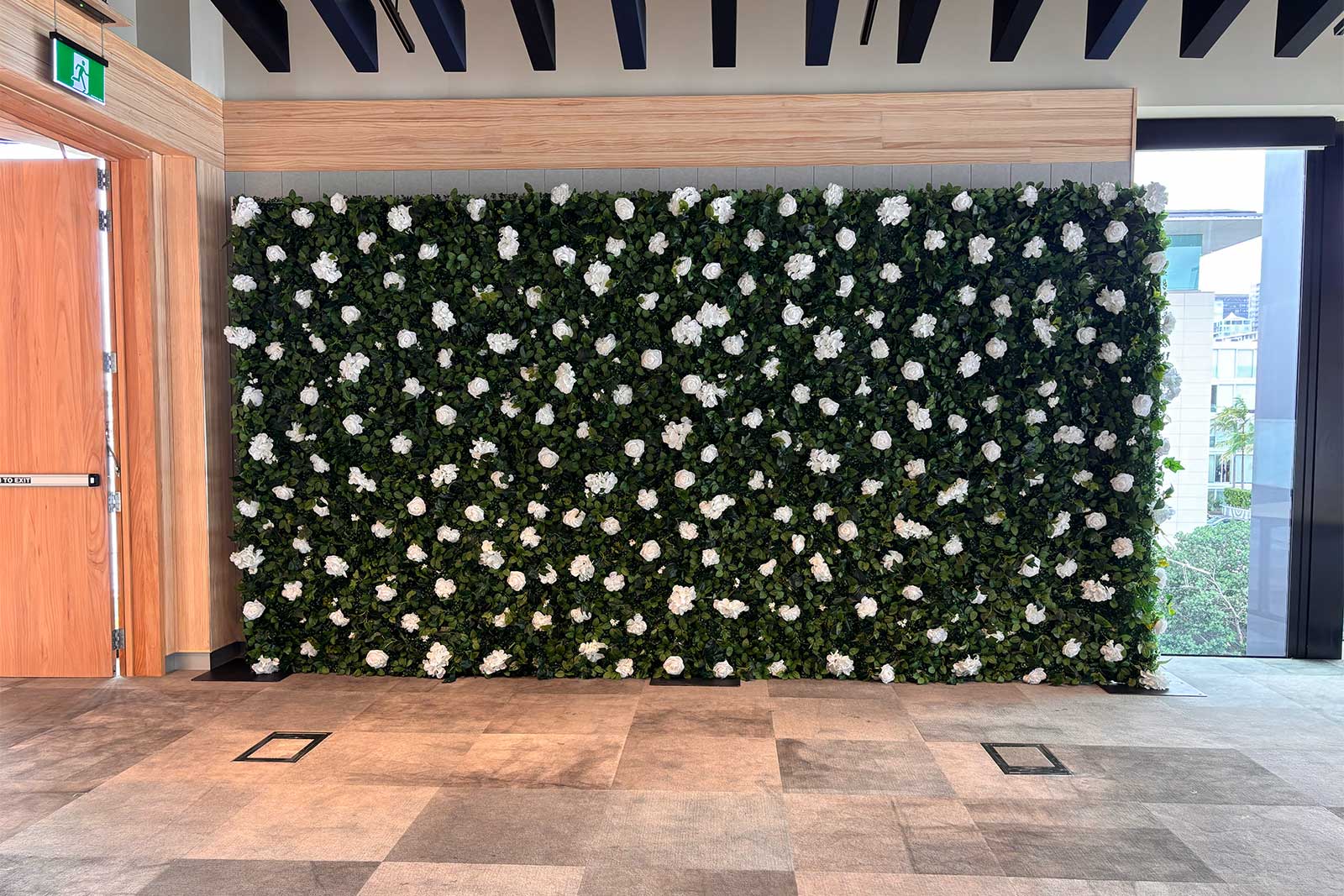 Professional green and white floral backdrop for corporate gatherings and photo opportunities