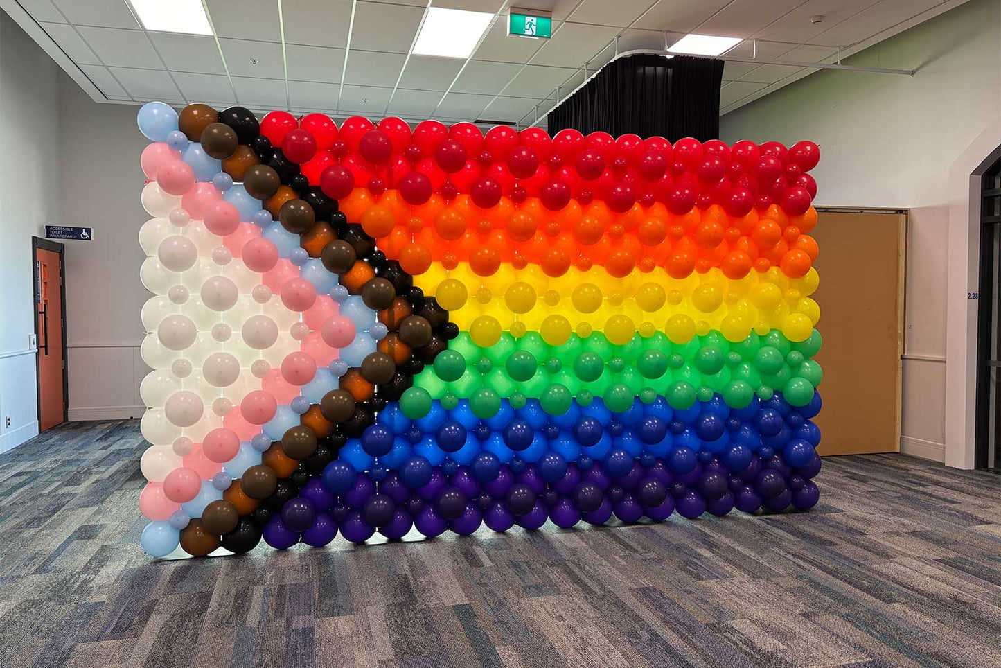 Custom rainbow balloon backdrop and Pride balloon wall designed for photo opportunities, corporate Pride events, LGBTQIA+ celebrations, festivals and special occasions throughout Auckland.