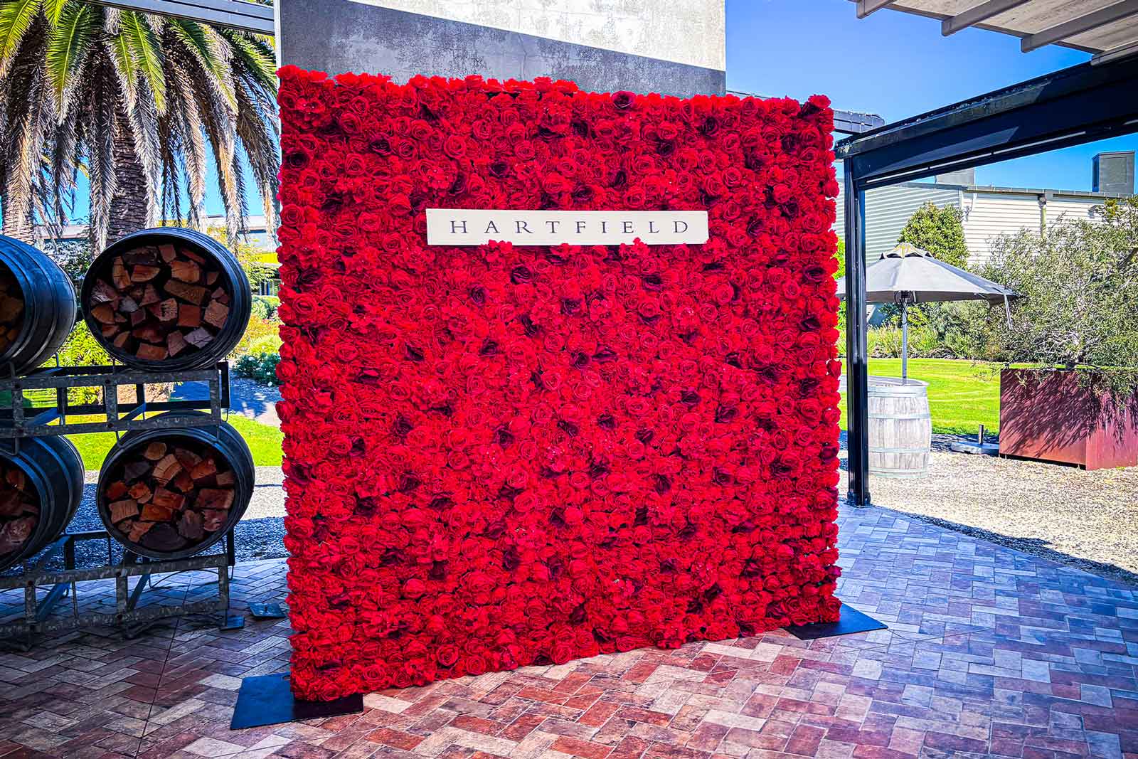 Red floral wall backdrop for corporate photo booth and networking events Auckland New Zealand