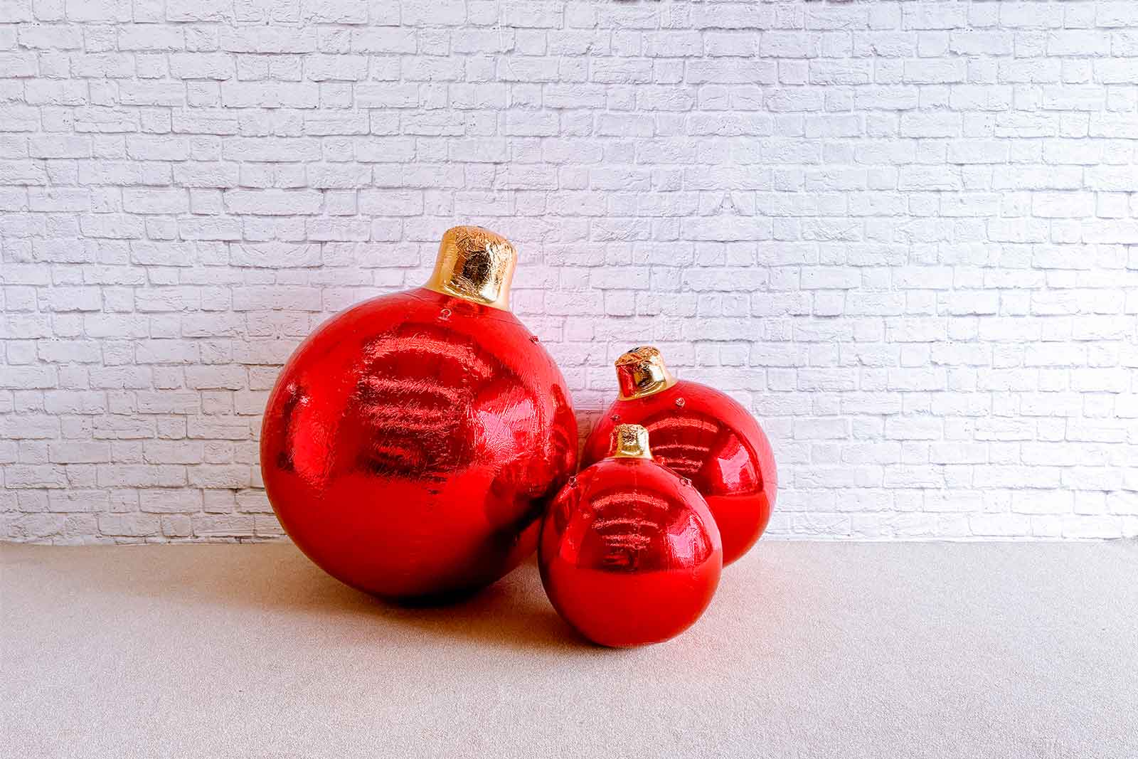 Red inflatable Christmas baubles for festive holiday decorations