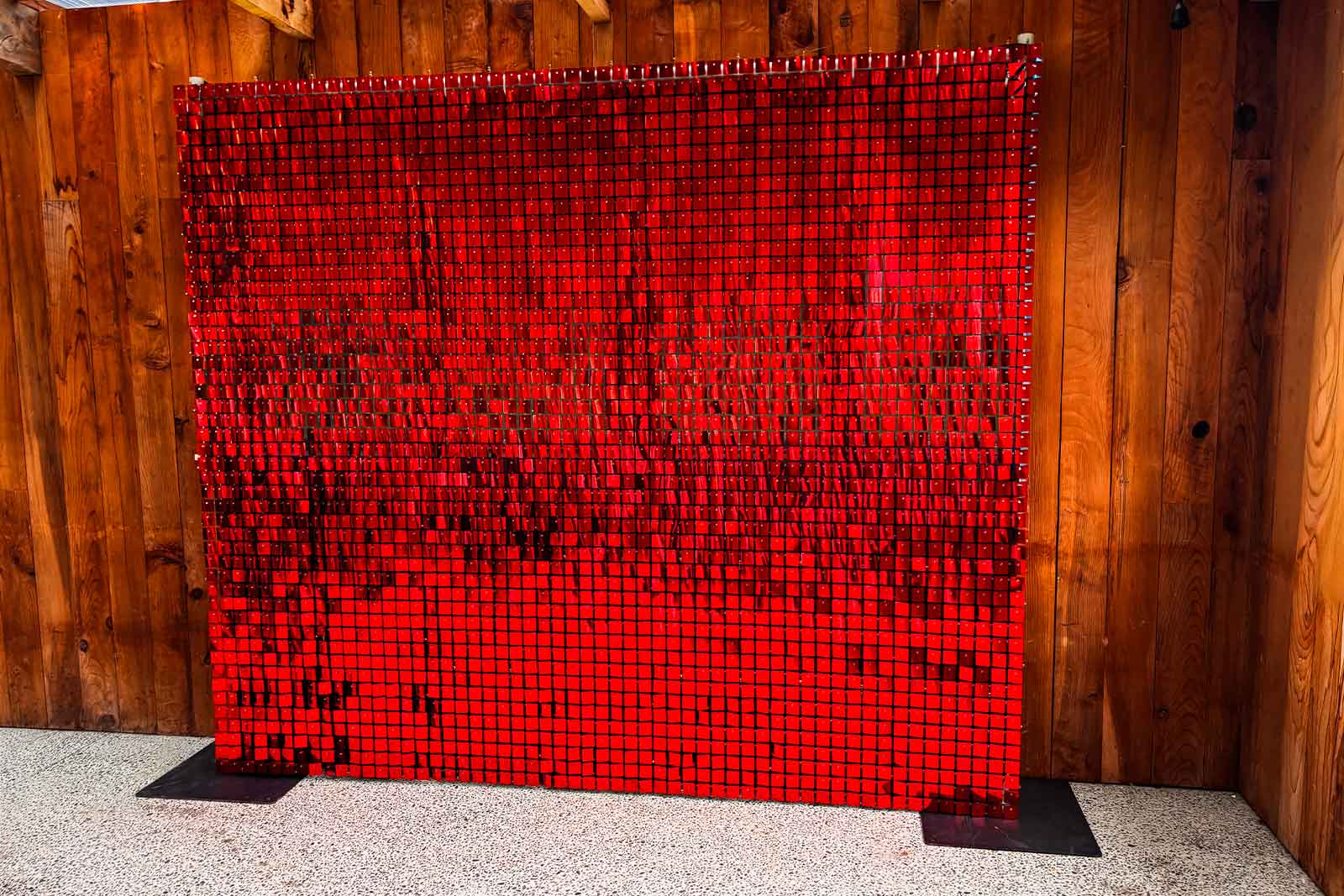 Red shimmer wall backdrop at corporate event in Auckland