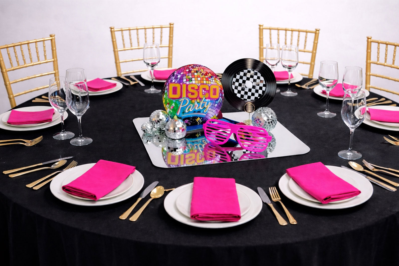 Retro disco party centrepiece with glittering disco balls and colorful lights, perfect for lively event tables