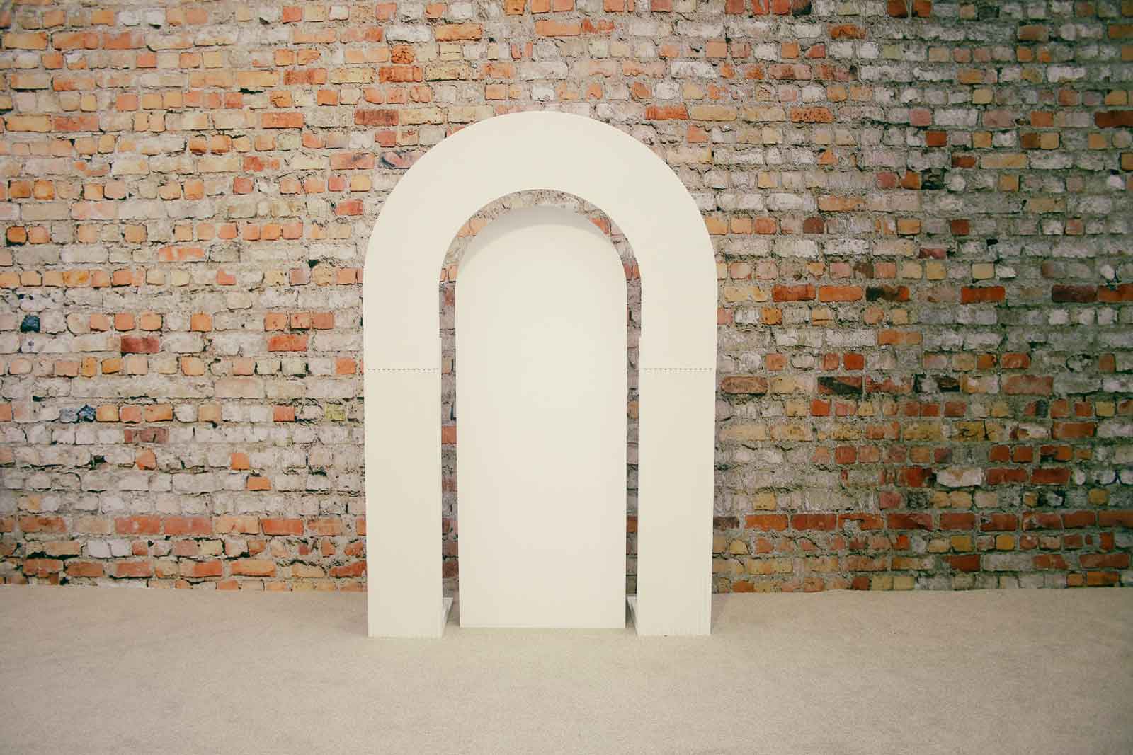 Ribbed arch backdrop with plain centre creating a modern and versatile photo area for events