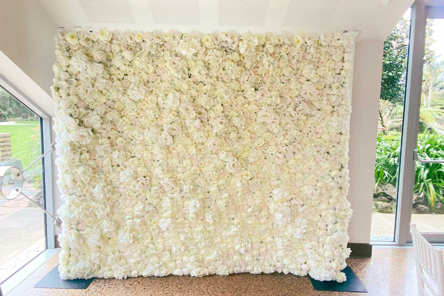 Romantic white flower wall backdrop for weddings and bridal portraits