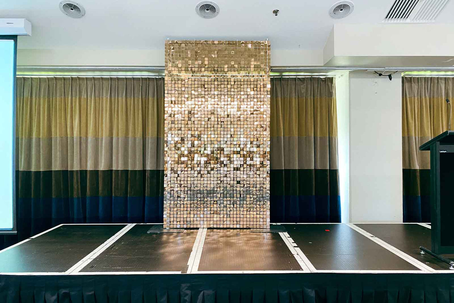 Elegant rose gold shimmer wall backdrop creating a modern and professional corporate event look