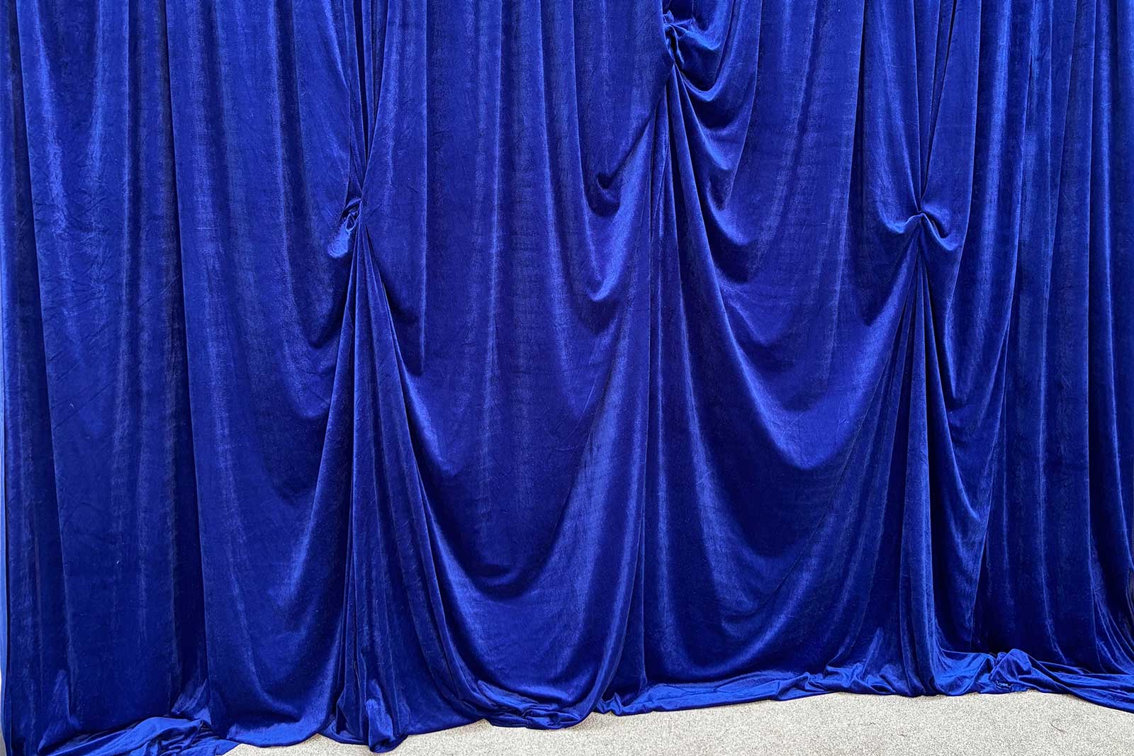 Royal blue draping for hire to enhance corporate events, launches, and celebrations