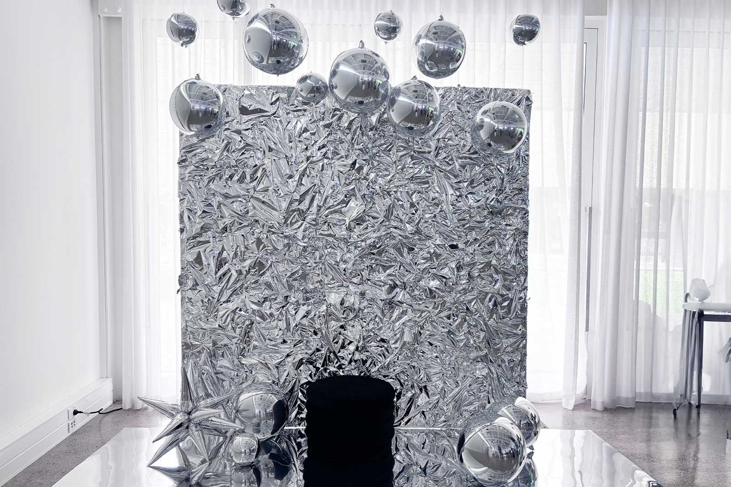 Silver crinkle foil wall backdrop for corporate event branding and photo activation