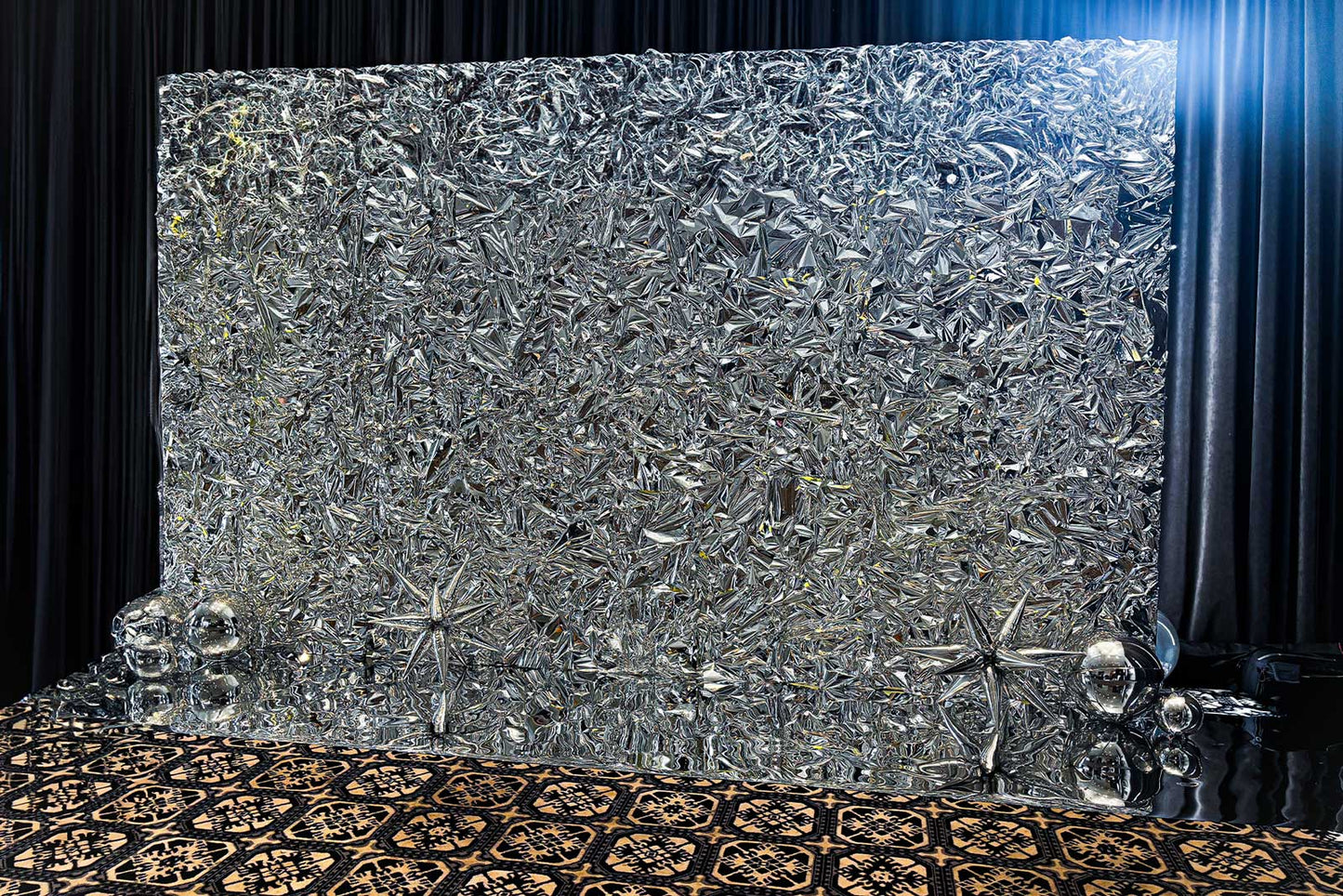 Silver metallic crinkle foil wall creating a glamorous event photo backdrop