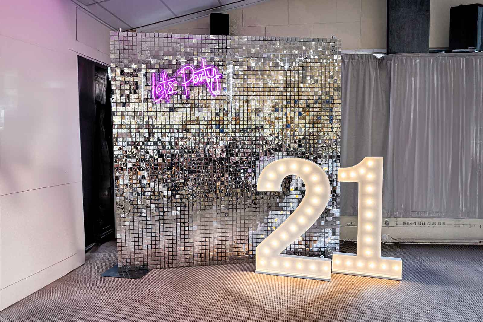 Silver shimmer wall backdrop creating a stylish and fun photo area for a 21st birthday