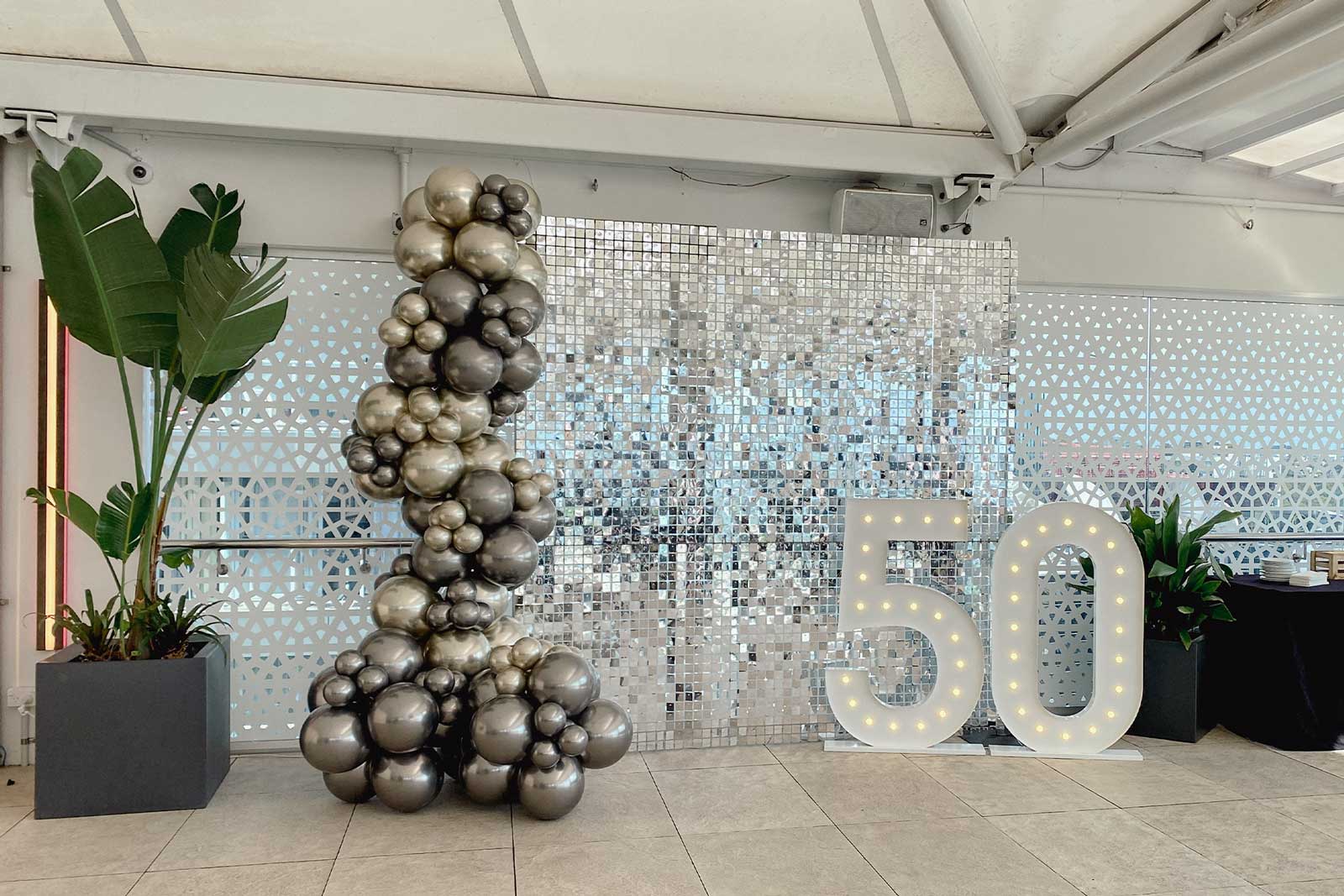 Silver shimmer wall with 50 glowing marquee lights for stylish and modern event décor