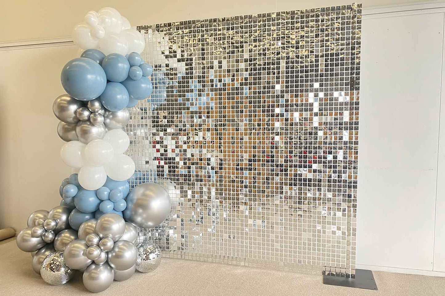 Sleek silver shimmer wall backdrop for corporate parties and team celebrations