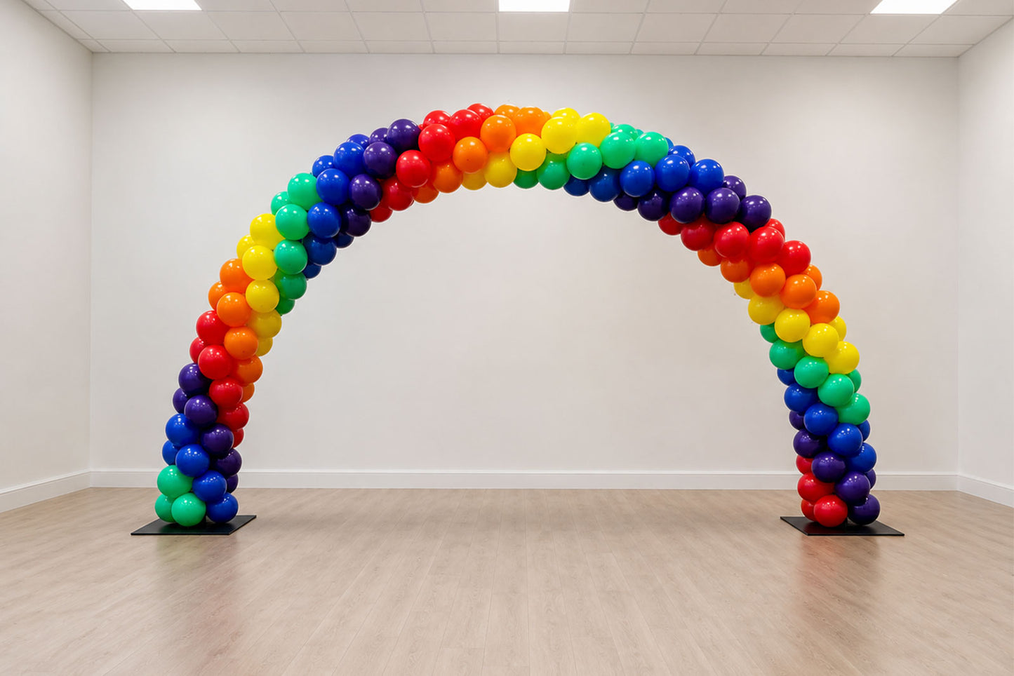 Spiral rainbow balloon arch hire by Mad Dog Backdrops featuring vibrant rainbow balloons, perfect for Pride events, corporate celebrations, festivals, entrances and community events in Auckland.