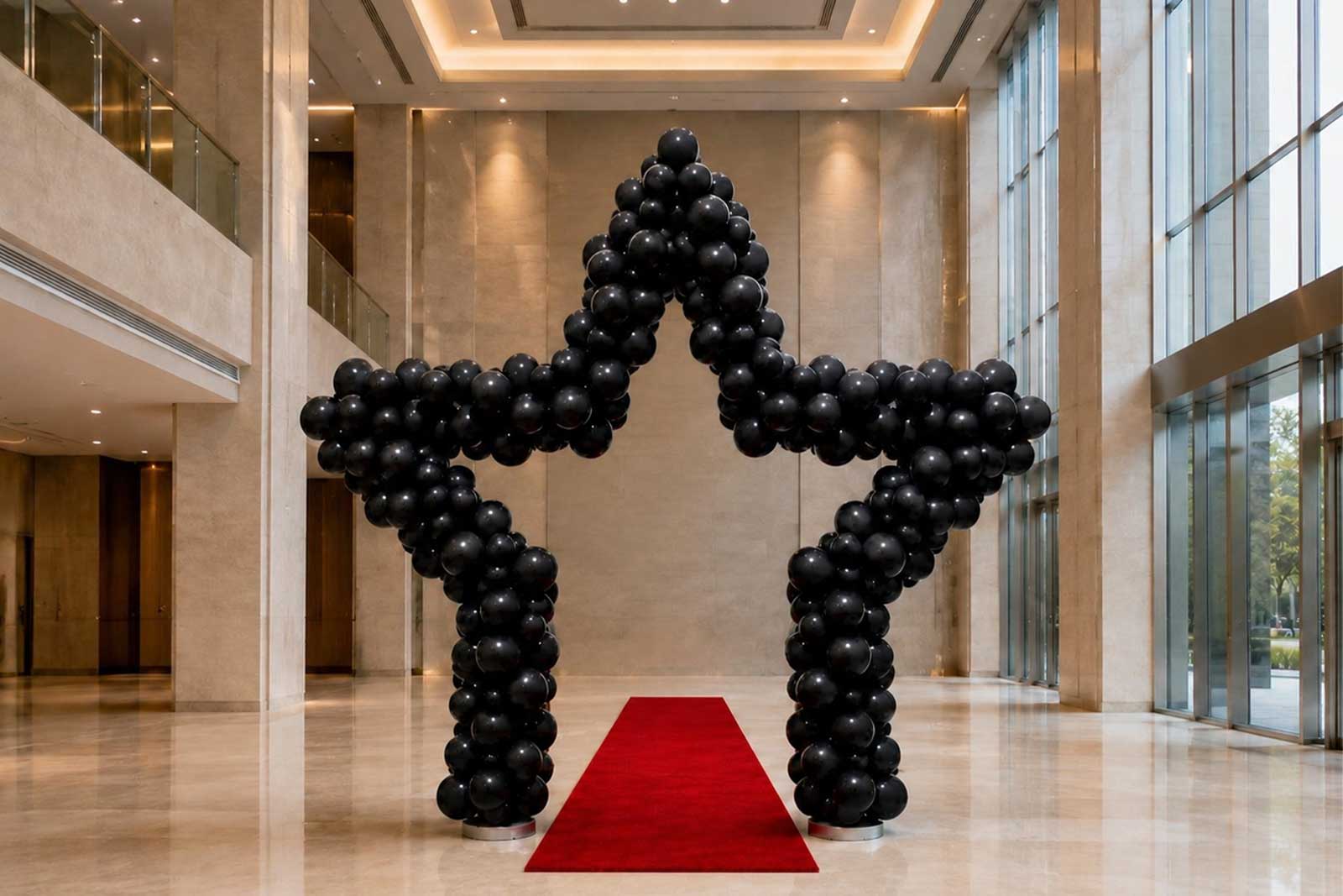Star balloon arch in gold and white balloons creating a festive backdrop for an Auckland event