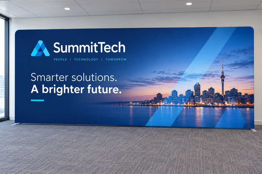 Straight tension media wall with custom corporate branding in a modern conference setting
