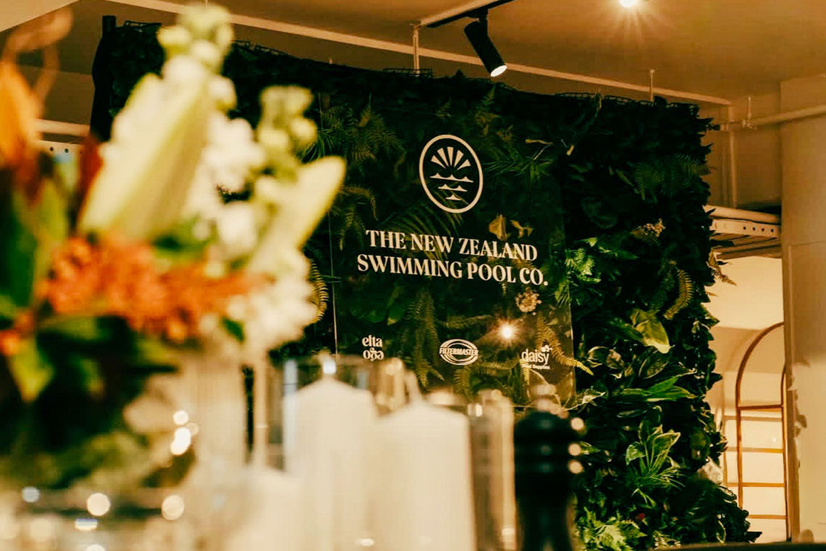 Tropical themed event wall with lush greenery and vibrant tropical foliage for event decoration