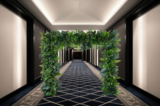 Tropical Oasis Greenery Frame with lush tropical foliage and monstera leaves, designed as a walk-through entrance feature and photo backdrop for weddings, corporate events, and tropical-themed celebrations in Auckland.