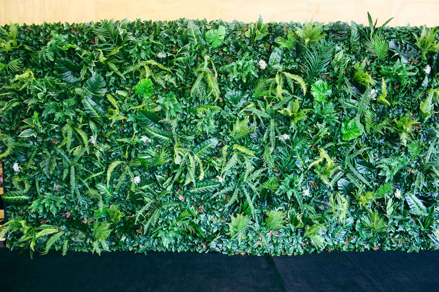 Tropical palm leaf wall backdrop for hire, creating a lush island-style setting for events and celebrations in Auckland
