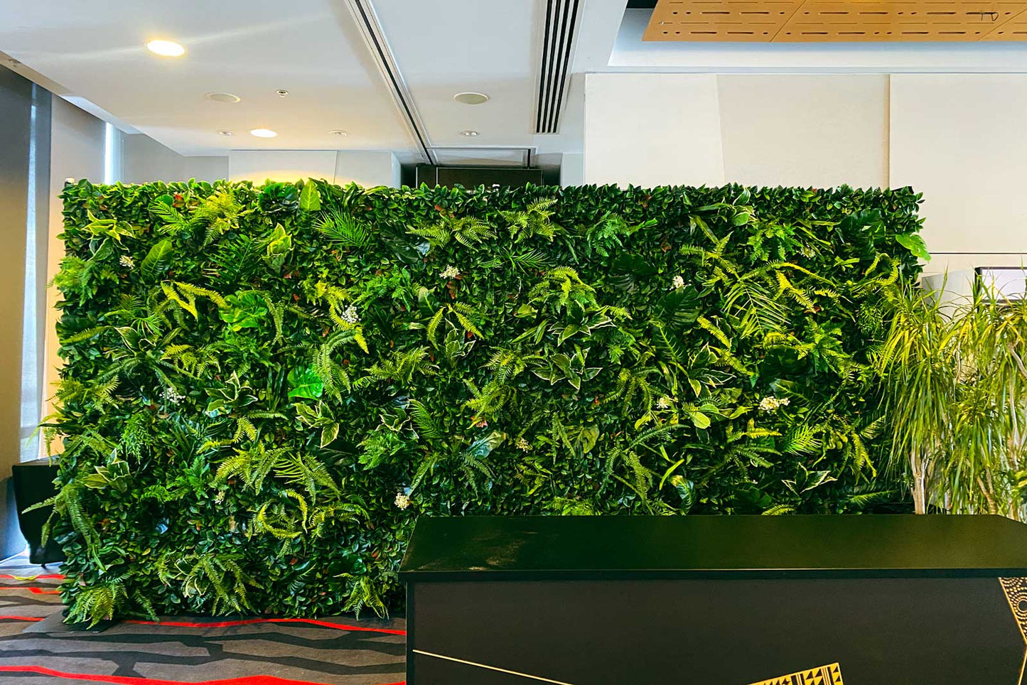 Tropical photo backdrop wall hire featuring dense greenery ideal for event photography and styling
