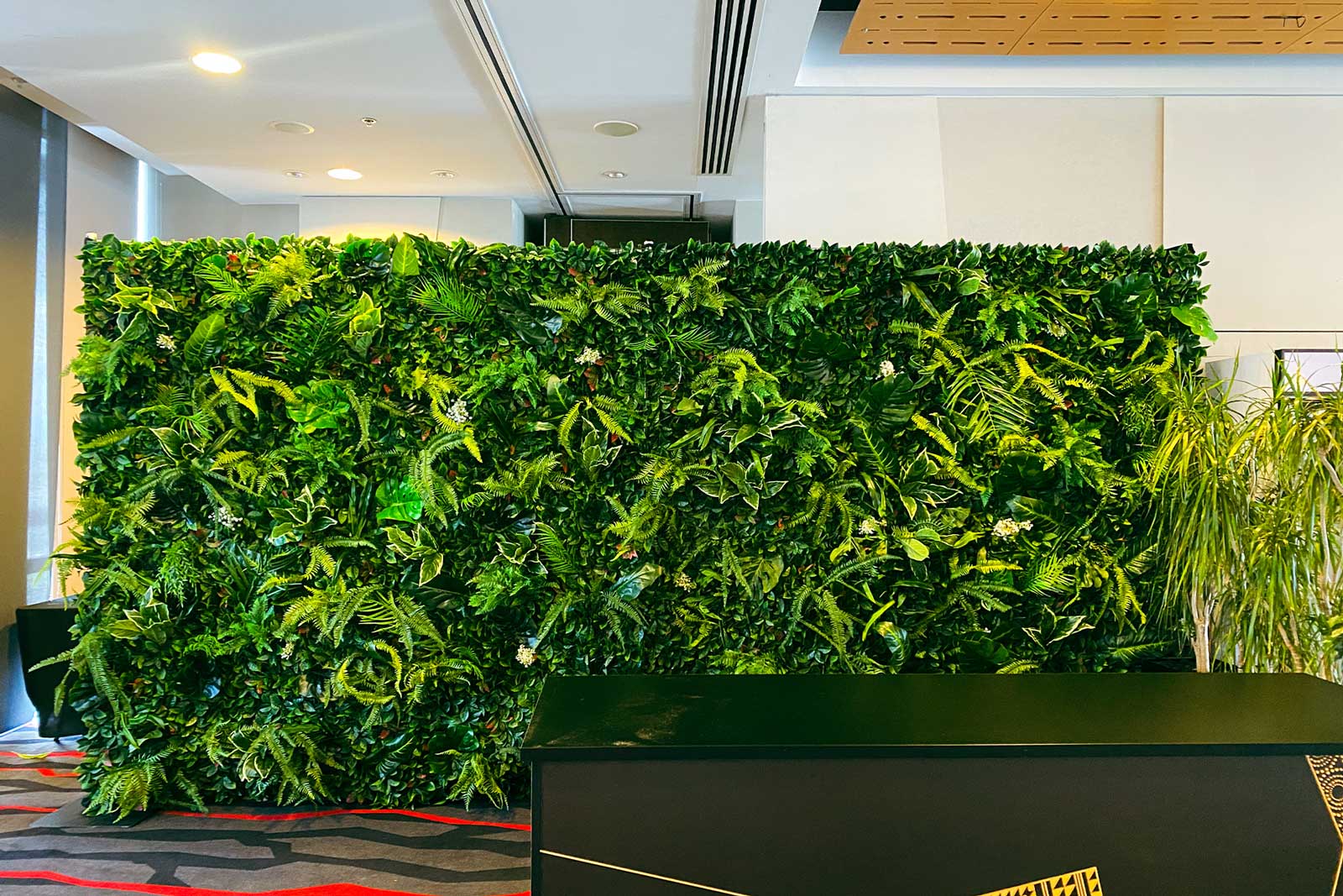 Tropical photo backdrop wall hire featuring dense greenery ideal for event photography and styling