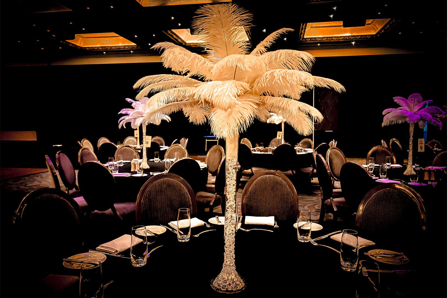 White feather centrepiece adding height and sophistication to a corporate gala dinner table