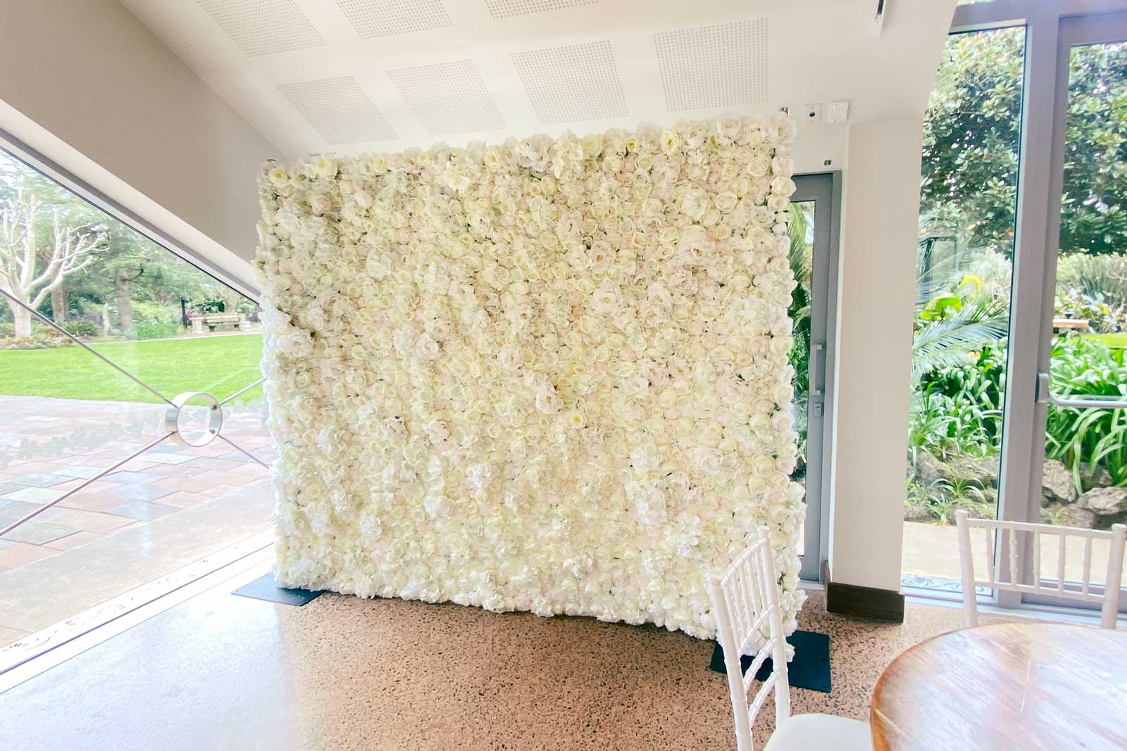 Elegant white flower wall party backdrop hire for bridal showers and celebrations