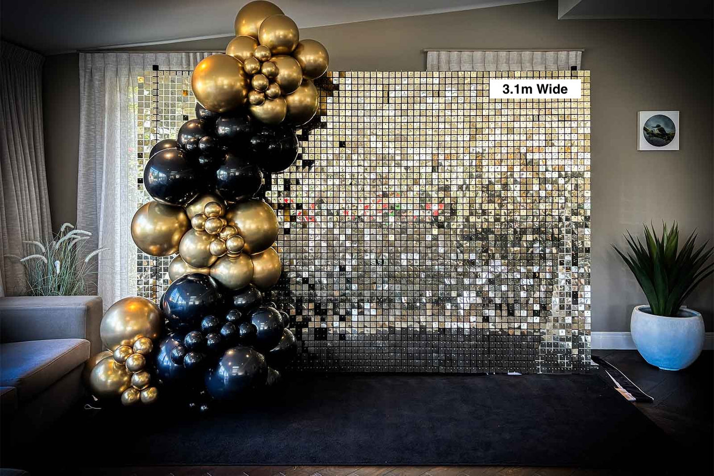 White and gold shimmer wall backdrop styled with coordinated balloon arrangement for events and photo displays