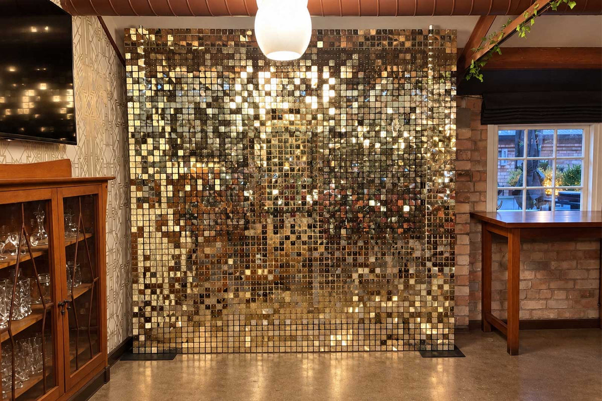 White and gold shimmer wall backdrop for elegant event styling