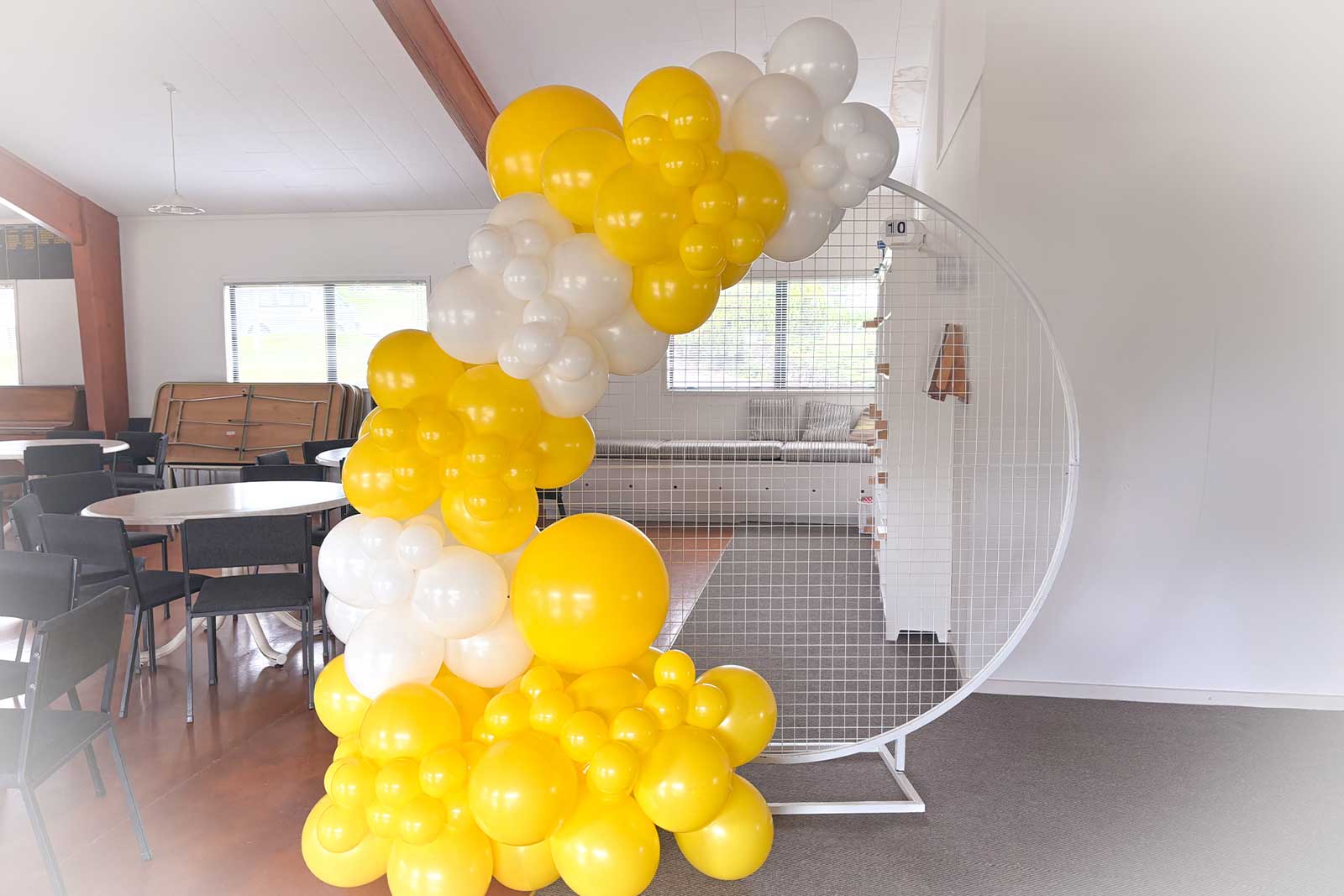 White mesh circle backdrop with balloon garland for celebrations