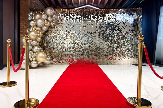 White shimmer wall with red carpet setup for corporate events, ideal for photo backdrops and stylish entrances