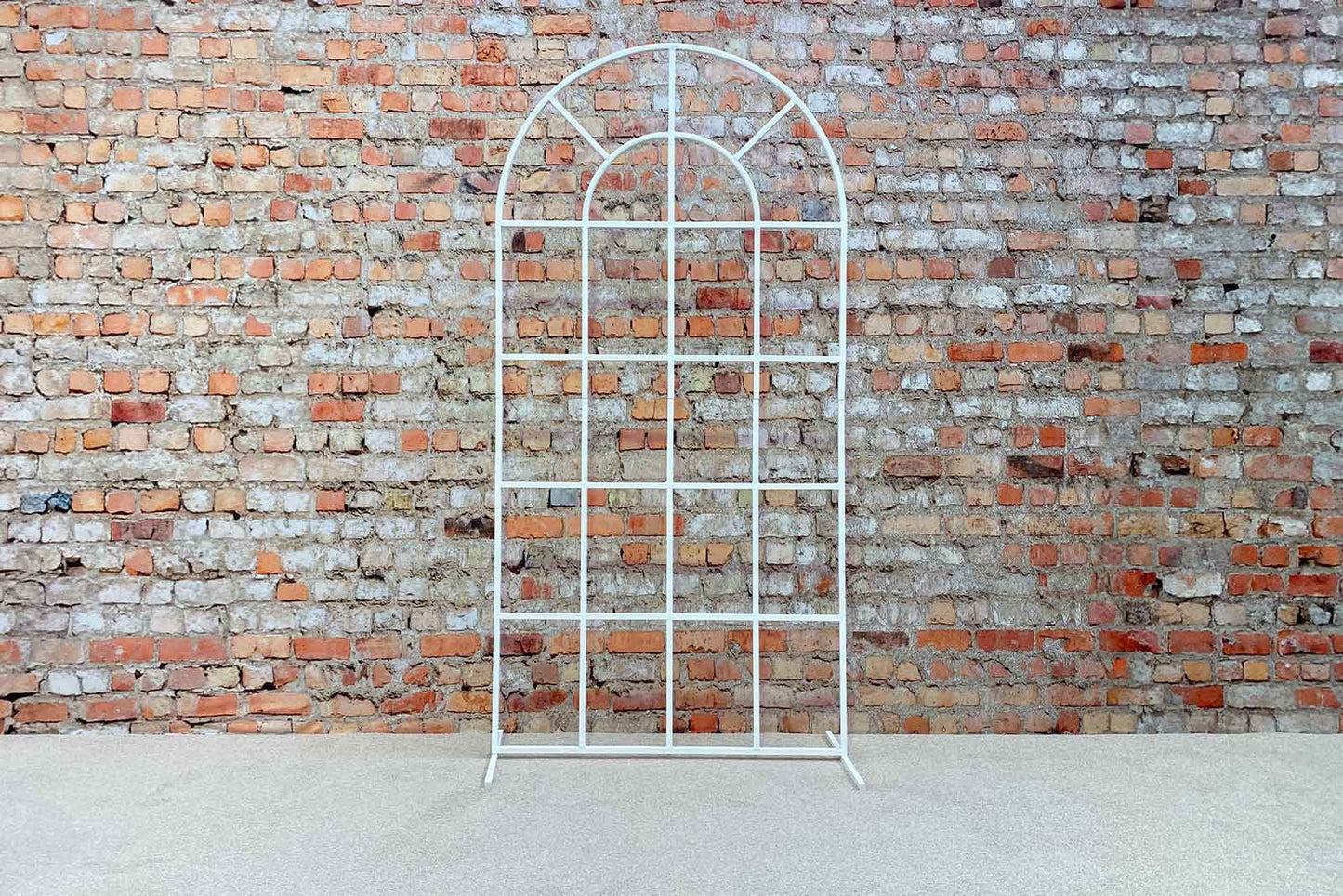 White window arch backdrop creating an elegant and modern photo area for events