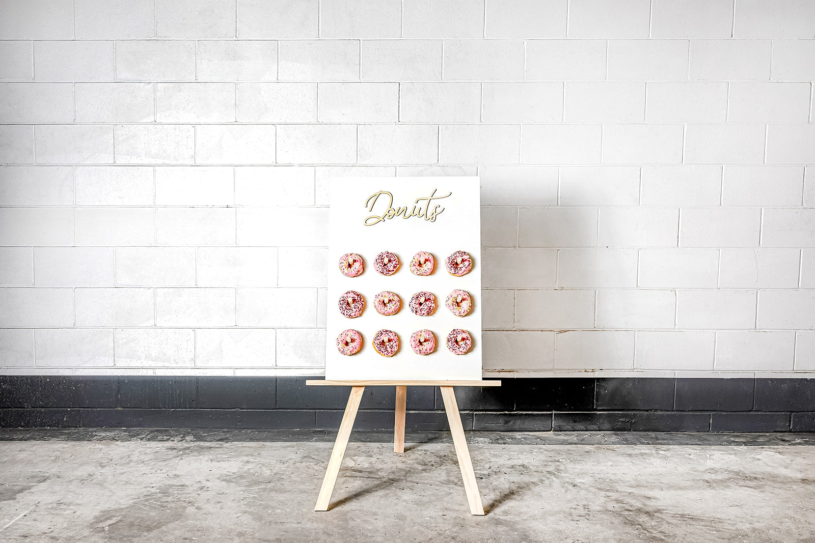 Colourful donut wall for hire to create a fun and interactive event dessert station