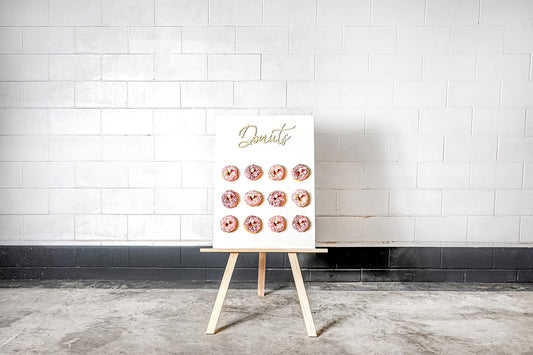 Colourful donut wall for hire to create a fun and interactive event dessert station, wedding, 21st, baby shower