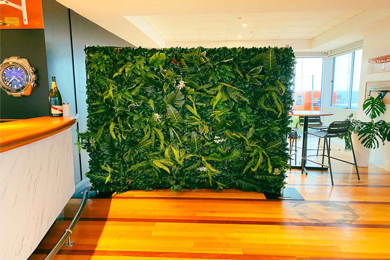 Corporate event tropical wall with lush foliage backdrop