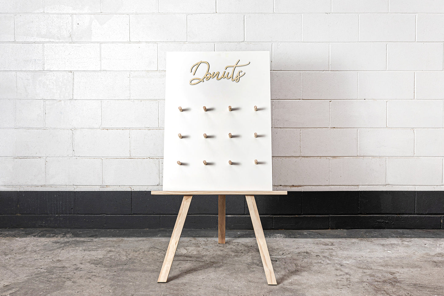 Donut wall displayed on easel stand for event dessert station in Auckland